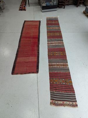 two rugs that are on the floor in a room