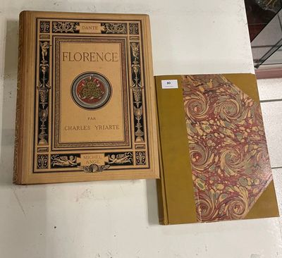 an old book with a gold cover sitting on top of a white table
