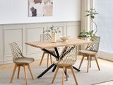 a wooden table with four chairs and a vase on top of it
