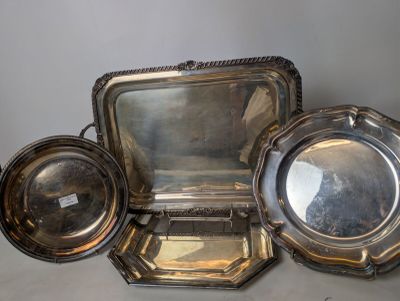 three silver trays and a mirror sitting on a table