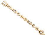 a gold bracelet with black dots on it