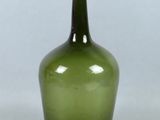 an image of a green glass bottle on a white background
