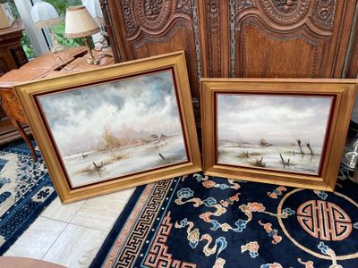 two framed paintings of boats on the water in a living room