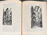 an open book on a table with a drawing of a street