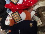 a pile of clothes and other items on a bed