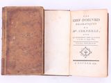 an open book with a brown cover sitting on top of a white surface