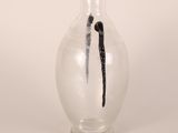 a vase with a vanilla stick sticking out of it