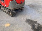 a small red machine that is parked in a parking lot