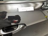 a man taking a picture of a car with a video camera