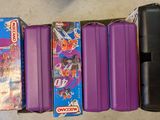 purple suitcases are lined up in a row on the floor