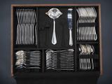 many forks and spoons in a wooden box