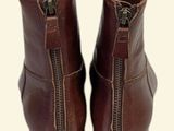 pair of brown leather boots with zippers on the side of them