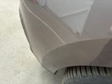 a close up of a car ' s front bumper with a hole in it