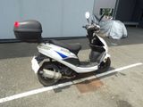 a scooter parked in a parking lot next to a building