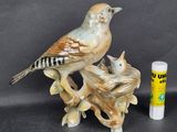 a bird sitting on top of a tree branch next to a tube of lip bale