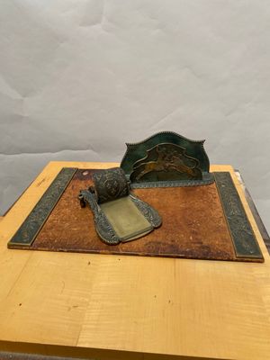 a wooden table topped with a metal object on top of a wooden table