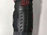 a close up of a black and red knee pad on a white background