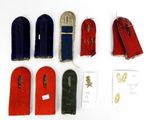 several pairs of red, blue, and green shoes are laid out on a white surface