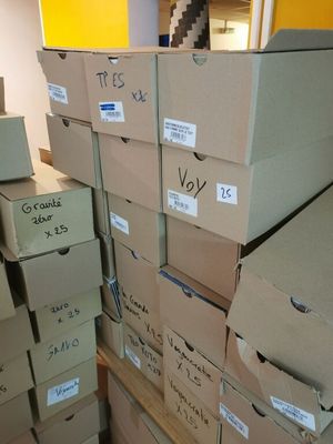 several boxes are stacked on top of each other in a room