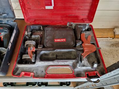 a red tool box with tools in it on a table
