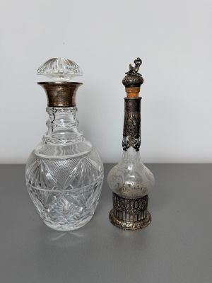 pair of antique cut glass decanters and a silver plated bottle