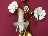 a wall mounted vase with flowers on it on the wall