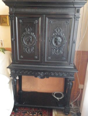a black cabinet with a clock on top of it