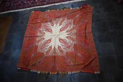 a large red and white rug on the floor