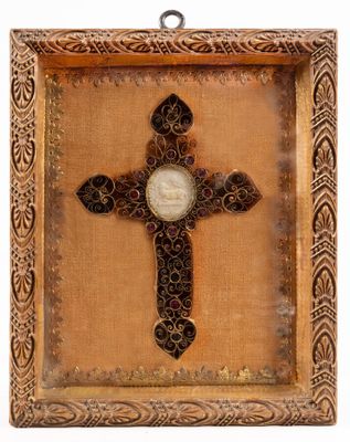a close up of a cross with a picture of a person on it