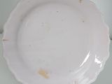 a white plate that has a yellow spot on it