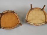 pair of antique wicker chairs with wooden legs and seat