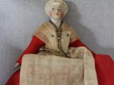 a figurine of a woman sitting in a red car