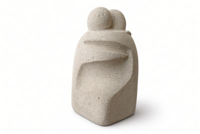 a stone sculpture of a man and a woman on a white background