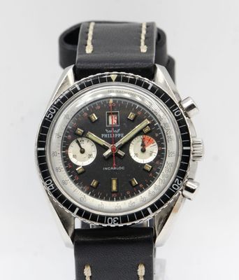 a close up of a watch on a white surface with a black strap