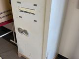 a refrigerator that is sitting in a room next to a wall