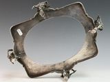 a silver frame with flowers on it on a table