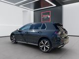 the back end of a blue volkswagen e - golf parked in a showroom