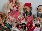 a lot of dolls that are sitting on a table