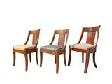 three wooden chairs with upholstered seats are shown against a white background