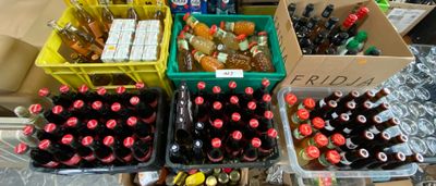 many boxes of sodas and soda bottles on the table