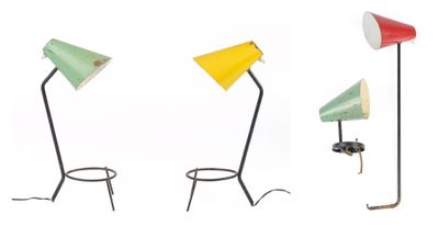three different colored lamps sitting on top of a table next to each other
