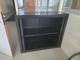 a black cabinet in the corner of a room