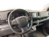 a steering wheel and dashboard of a car with a clock on it