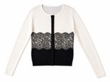 a white and black cardigan sweater with black lace trim