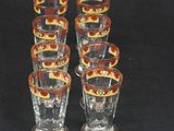 six shot glasses are lined up on a black surface