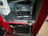 a red machine that has a fan and a radiator in it