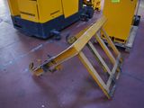 two yellow generators that are sitting in a warehouse