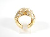a close up of a gold ring with pearls and diamonds