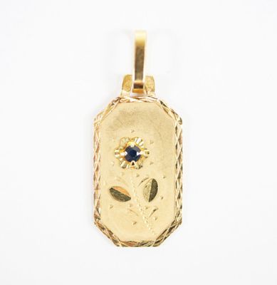 a close up of a gold locke with a blue stone in the center