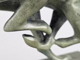 a bronze statue of a man holding a woman ' s hand